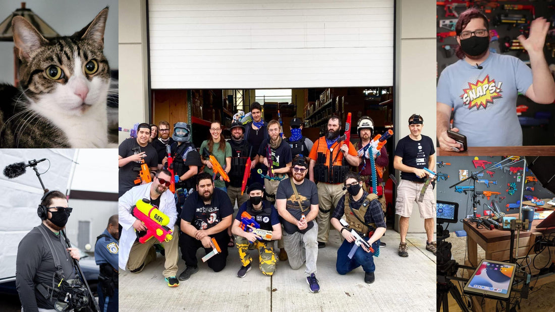 Group of people with Nerf modded blasters outside a shop, surrounded by hobby and workshop scenes